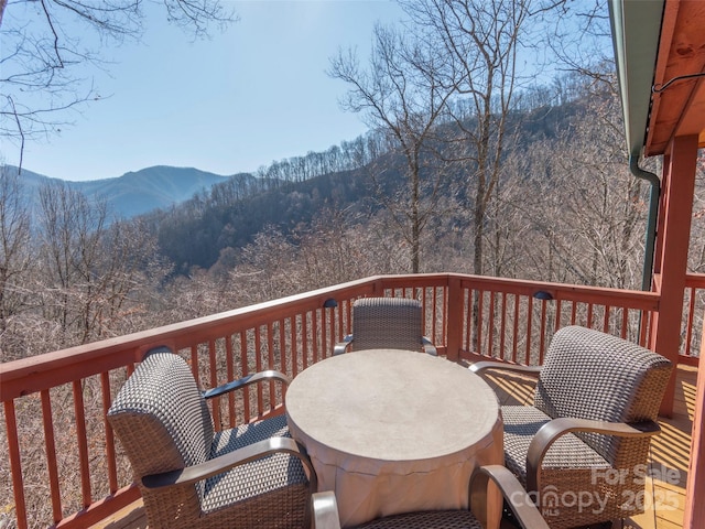 wooden deck with a mountain view