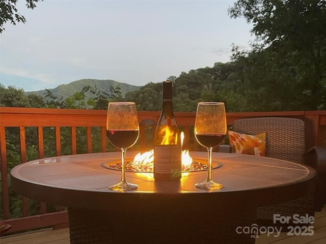 deck with a mountain view and an outdoor fire pit