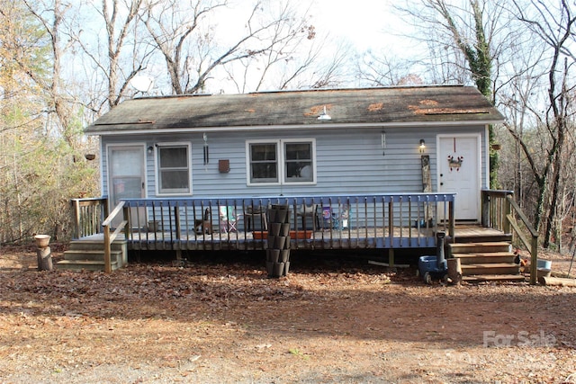 rear view of house featuring a deck