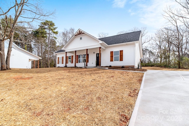 modern farmhouse style home with covered porch, concrete driveway, a front lawn, and a shingled roof