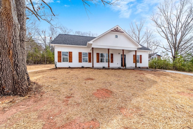 modern farmhouse style home with a porch and a shingled roof