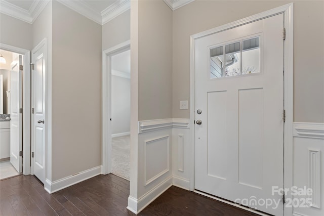 foyer entrance featuring dark wood-type flooring and ornamental molding