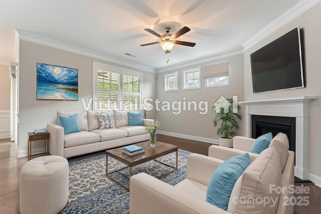 living room featuring ceiling fan, hardwood / wood-style flooring, and ornamental molding