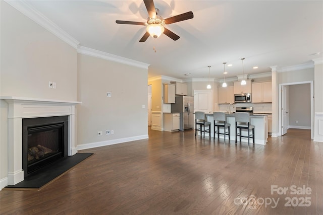 living room with dark hardwood / wood-style floors, ceiling fan, crown molding, and sink