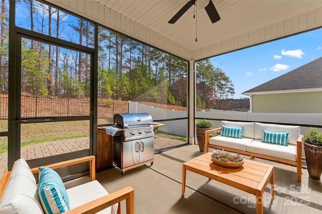 sunroom featuring ceiling fan