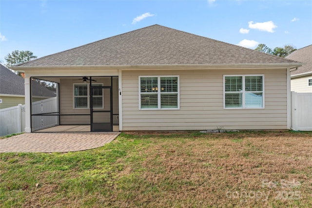 rear view of property with a lawn, a sunroom, ceiling fan, and a patio