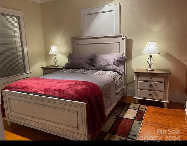 bedroom with wood-type flooring