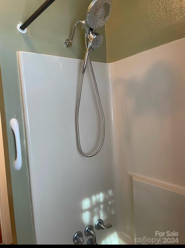 interior details featuring tub / shower combination