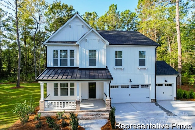 modern inspired farmhouse featuring a porch, a garage, and a front yard