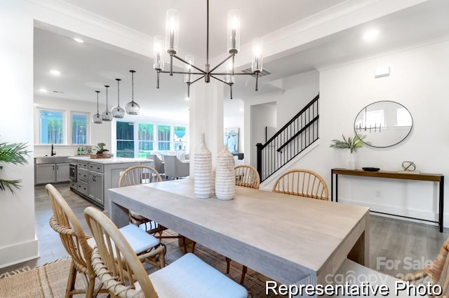 dining space with a chandelier, dark hardwood / wood-style floors, and sink