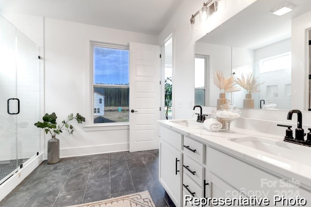 bathroom with vanity and a shower with door