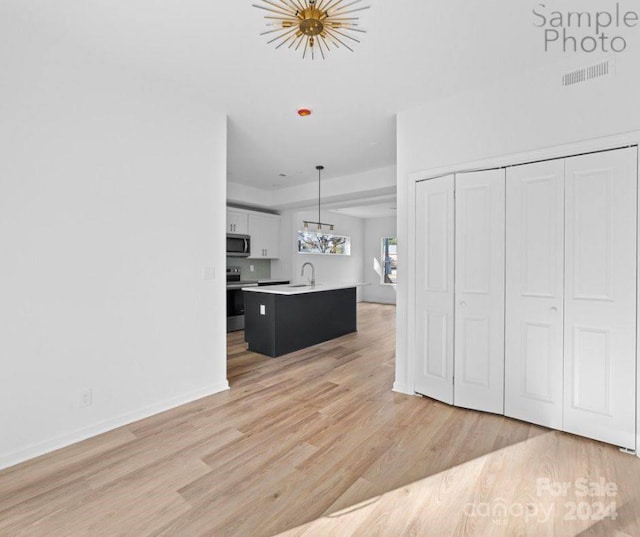 interior space with light hardwood / wood-style flooring and sink