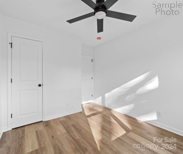 unfurnished room with ceiling fan and light hardwood / wood-style flooring