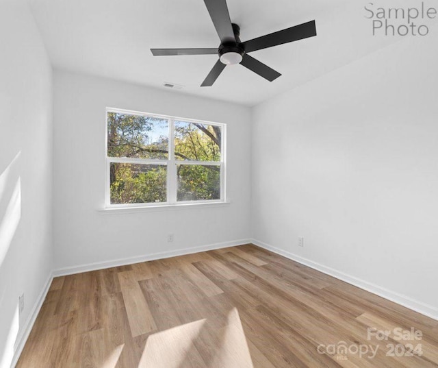 unfurnished room featuring ceiling fan and light wood-type flooring