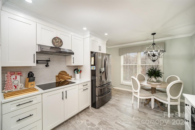 kitchen featuring white cabinetry, wall chimney range hood, stainless steel fridge with ice dispenser, a chandelier, and black electric stovetop