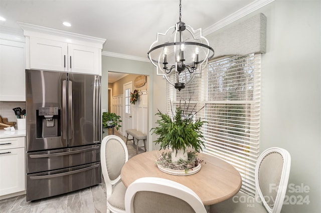 dining area with a chandelier and ornamental molding