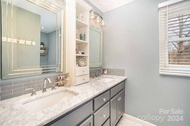 bathroom featuring vanity and backsplash