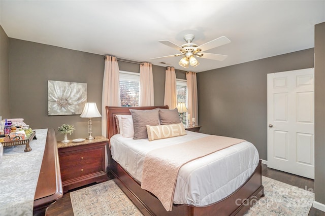 bedroom with ceiling fan and dark hardwood / wood-style flooring