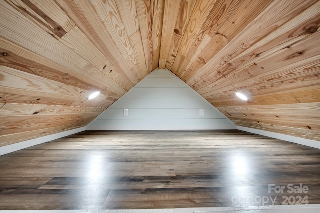 additional living space featuring wooden walls, hardwood / wood-style floors, wood ceiling, and vaulted ceiling