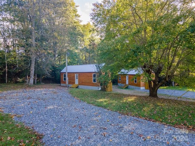 log cabin with a front lawn