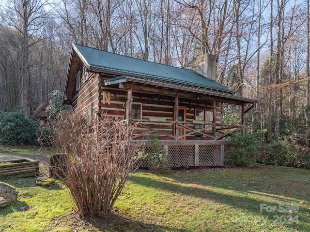 view of outbuilding with a yard