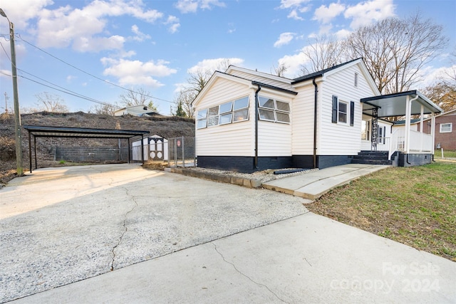 view of home's exterior featuring a carport