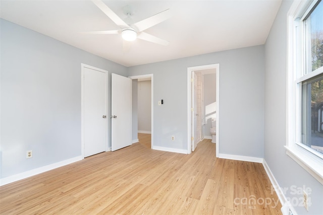 unfurnished bedroom with ensuite bathroom, light hardwood / wood-style flooring, and ceiling fan