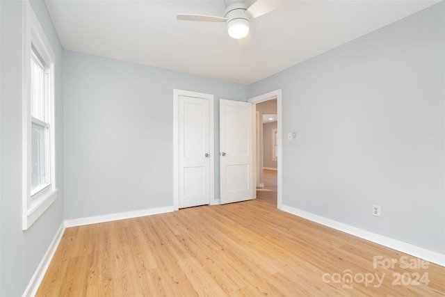 spare room featuring ceiling fan and light hardwood / wood-style flooring