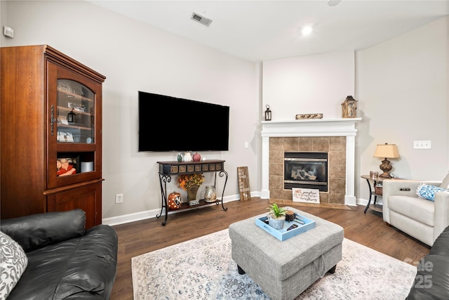 living room featuring a fireplace and dark hardwood / wood-style flooring