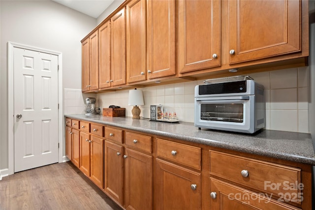 kitchen featuring light hardwood / wood-style floors and tasteful backsplash