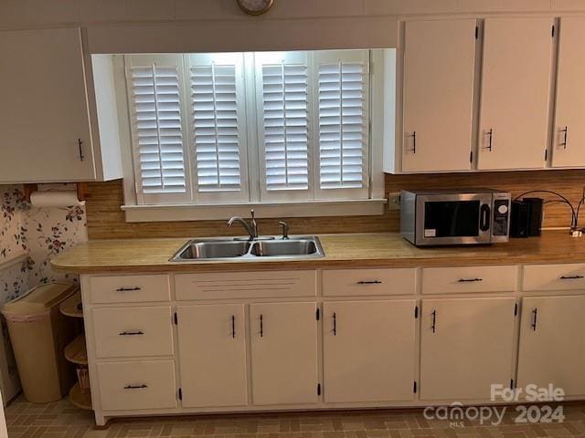 kitchen with white cabinets and sink