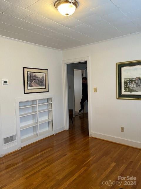 unfurnished room featuring dark hardwood / wood-style flooring