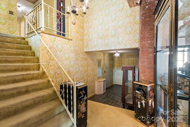 staircase featuring a chandelier