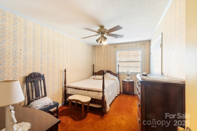 bedroom with carpet, a textured ceiling, ceiling fan, and ornamental molding