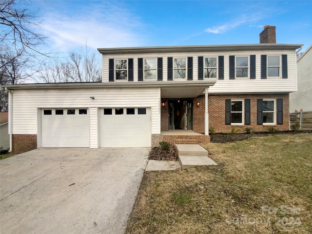 front facade with a front lawn and a garage