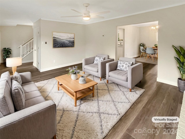 living room with ceiling fan with notable chandelier and wood-type flooring