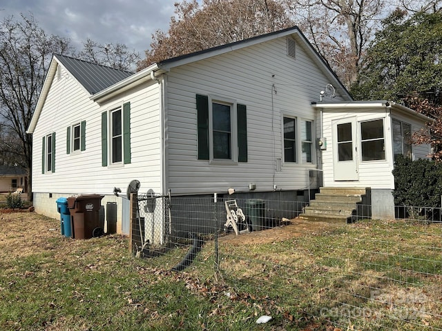 back of house with a lawn