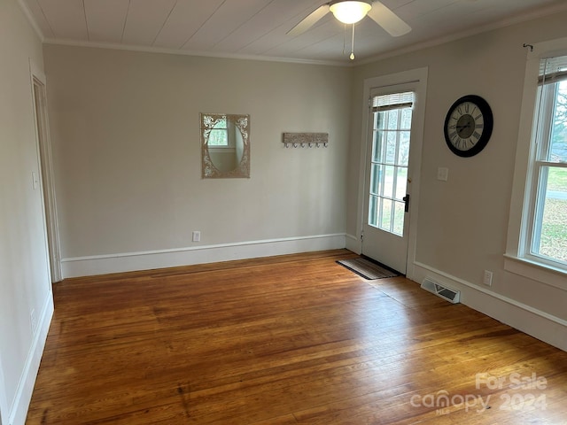 foyer entrance with hardwood / wood-style flooring, ceiling fan, and ornamental molding