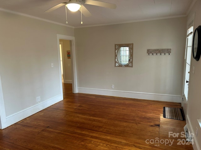 unfurnished room featuring ceiling fan, plenty of natural light, crown molding, and dark wood-type flooring