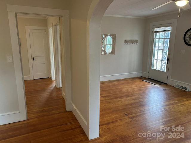 entryway with ceiling fan, hardwood / wood-style floors, and ornamental molding