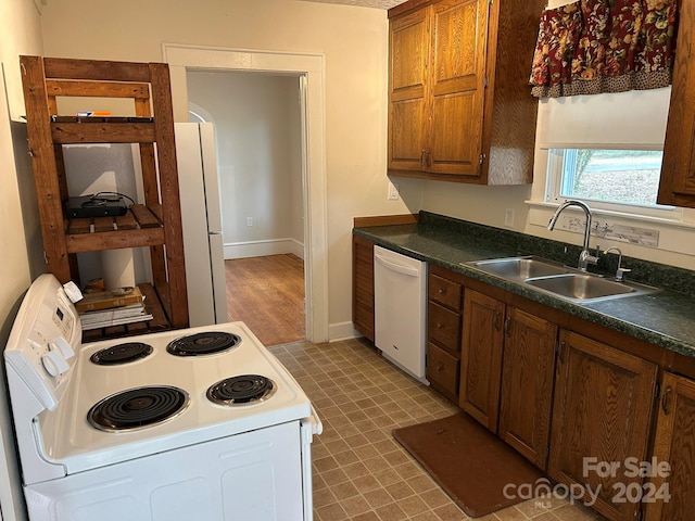 kitchen with white appliances and sink