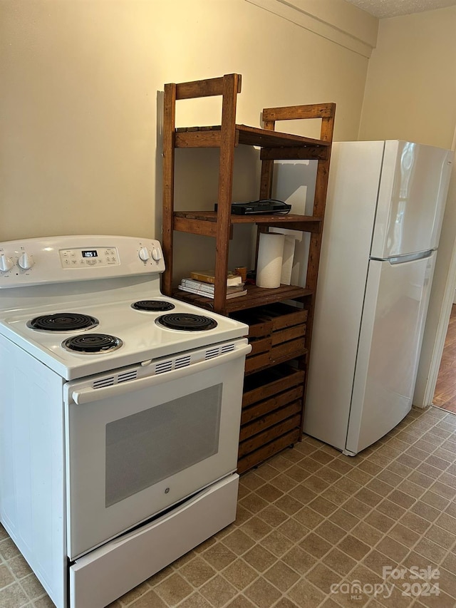 kitchen with white cabinets and white appliances