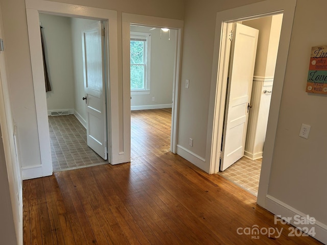 hallway with hardwood / wood-style floors