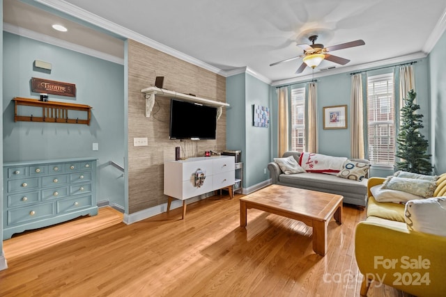 living room with ceiling fan, ornamental molding, and light hardwood / wood-style flooring