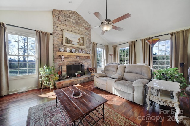 living room featuring a fireplace, lofted ceiling, ceiling fan, and dark wood-type flooring