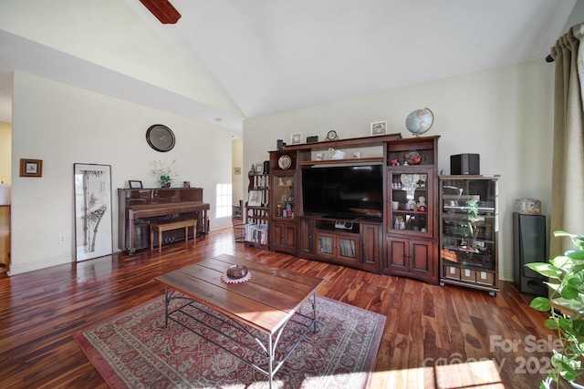 living room with dark hardwood / wood-style flooring and vaulted ceiling