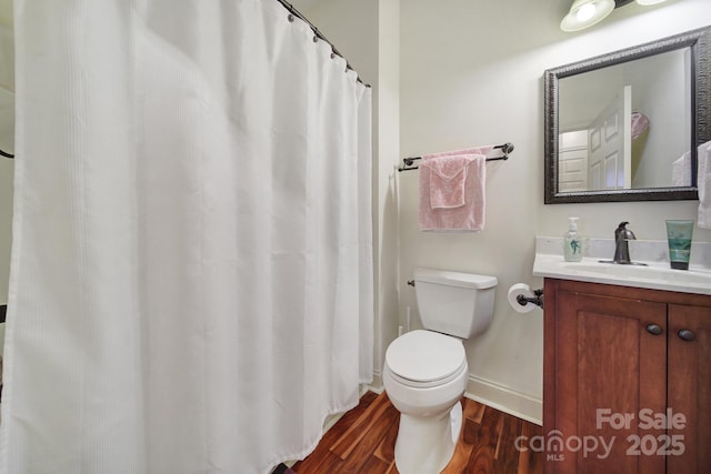 bathroom featuring hardwood / wood-style floors, vanity, and toilet