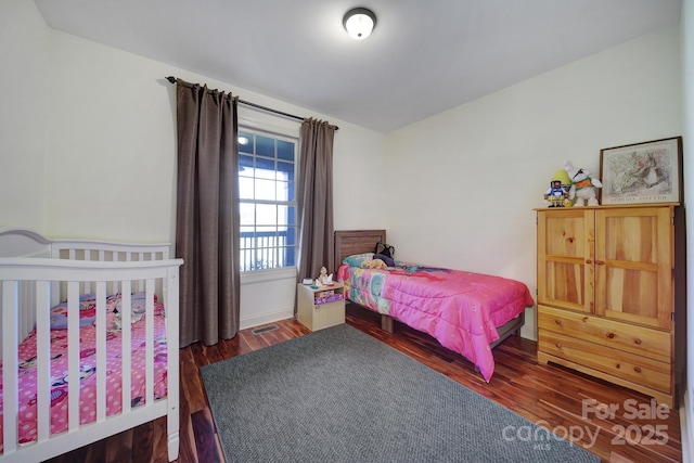 bedroom featuring dark hardwood / wood-style floors