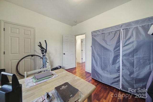 workout area featuring dark wood-type flooring