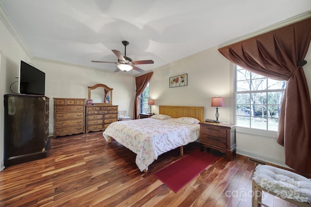 bedroom featuring ceiling fan, crown molding, and dark wood-type flooring